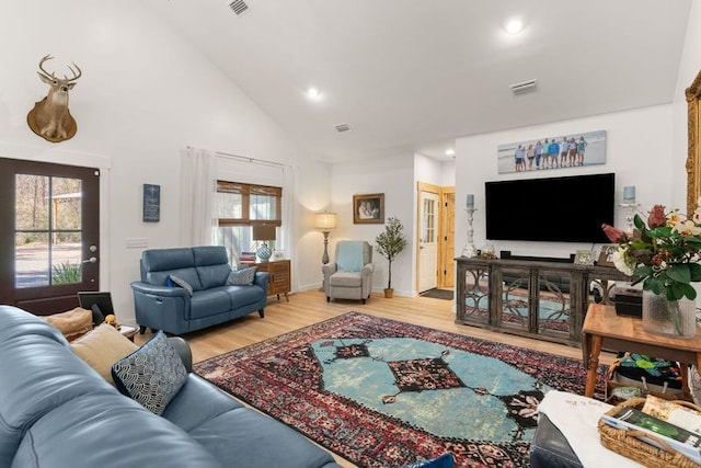 living area featuring visible vents, high vaulted ceiling, wood finished floors, and recessed lighting