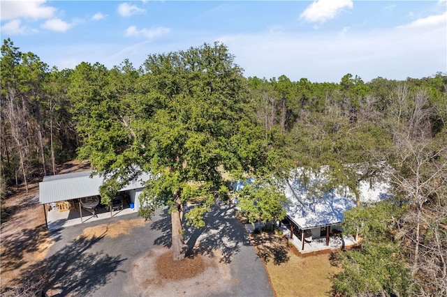 drone / aerial view featuring a wooded view