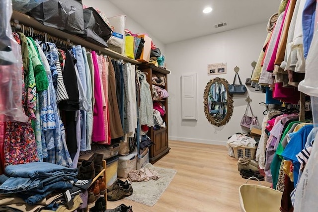 spacious closet with light wood-style flooring and visible vents