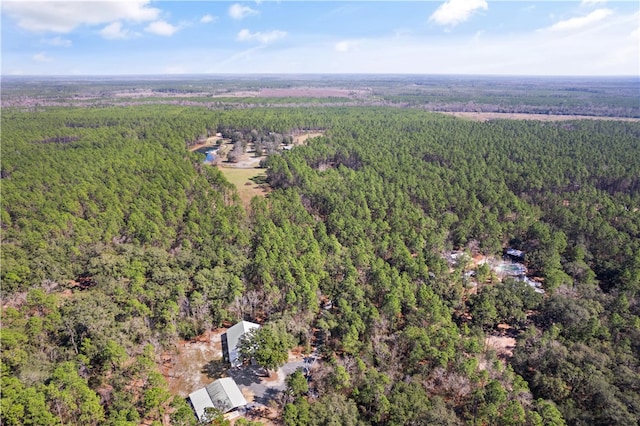 aerial view featuring a wooded view