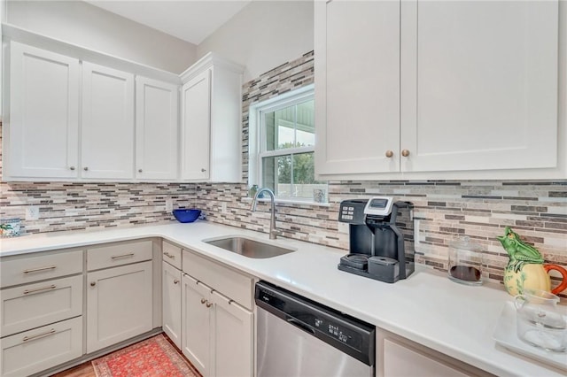 kitchen with dishwasher, tasteful backsplash, white cabinetry, and sink