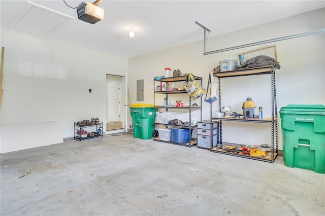 garage featuring electric panel and a garage door opener