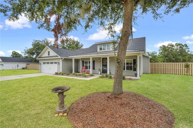 view of front facade with a porch, a garage, and a front lawn