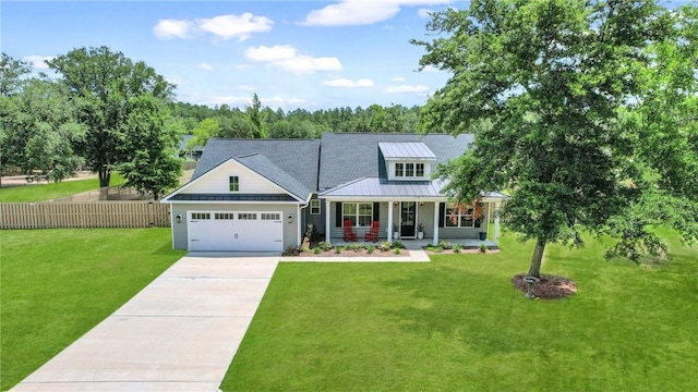 view of front facade featuring covered porch, a garage, and a front yard