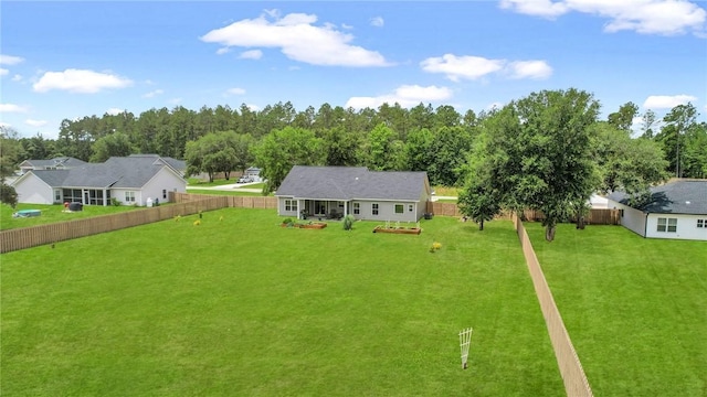 rear view of house featuring a yard