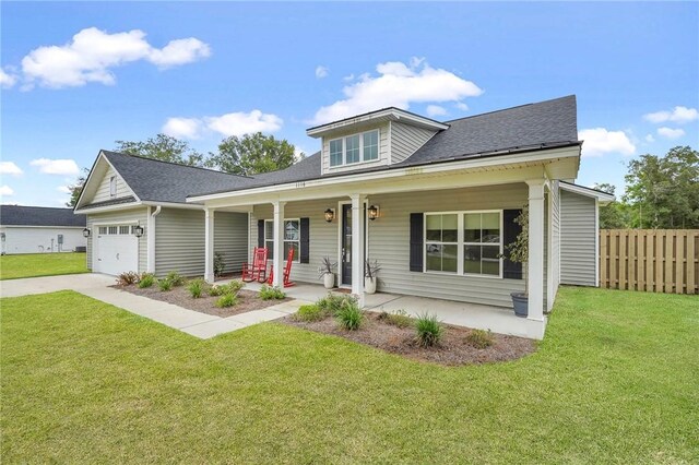 view of front of property with a front lawn, a porch, and a garage