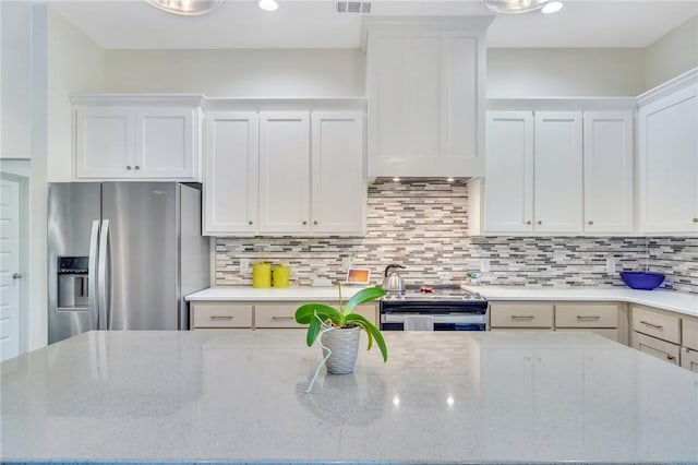 kitchen featuring white cabinetry, light stone countertops, and appliances with stainless steel finishes