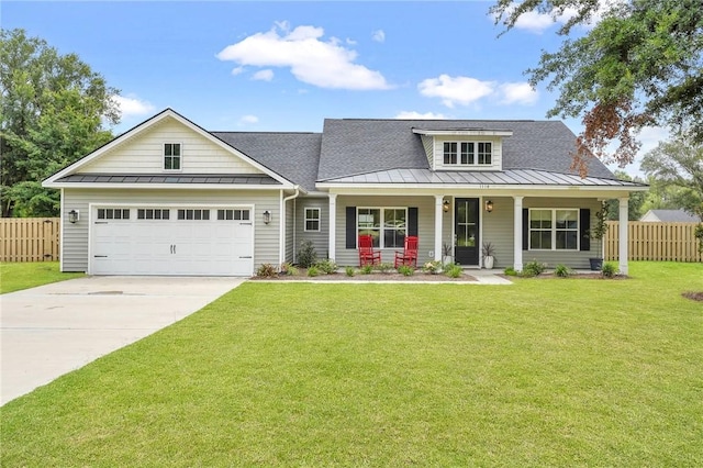 view of front of home with a front lawn, a porch, and a garage