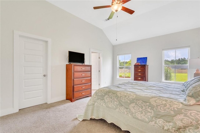 bedroom featuring ceiling fan, light colored carpet, multiple windows, and vaulted ceiling