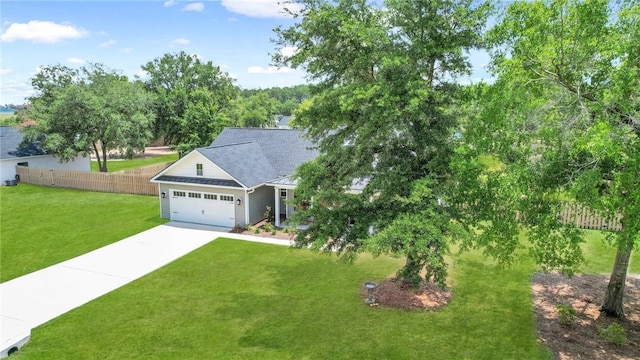 view of front of home featuring a front yard and a garage