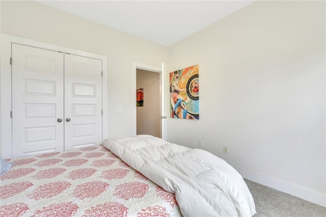 bedroom featuring light carpet and a closet