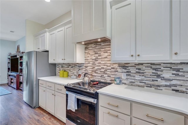 kitchen with backsplash, custom exhaust hood, stainless steel appliances, light hardwood / wood-style floors, and white cabinetry