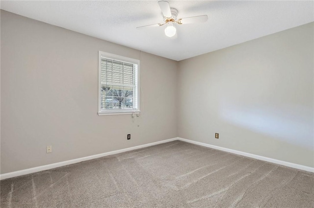 empty room featuring a textured ceiling, carpet floors, and ceiling fan