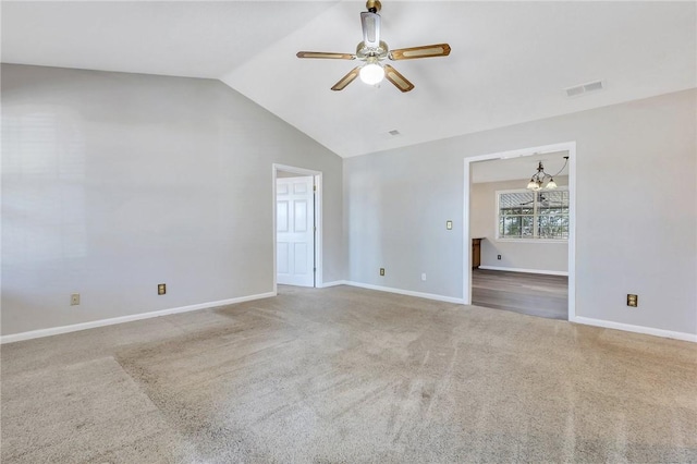 empty room with lofted ceiling, carpet flooring, and ceiling fan with notable chandelier