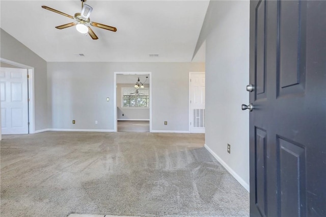 carpeted empty room with ceiling fan and vaulted ceiling