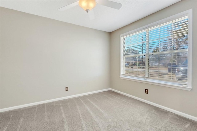 spare room with carpet and ceiling fan