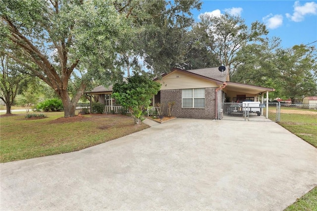 view of front facade with a carport and a front lawn