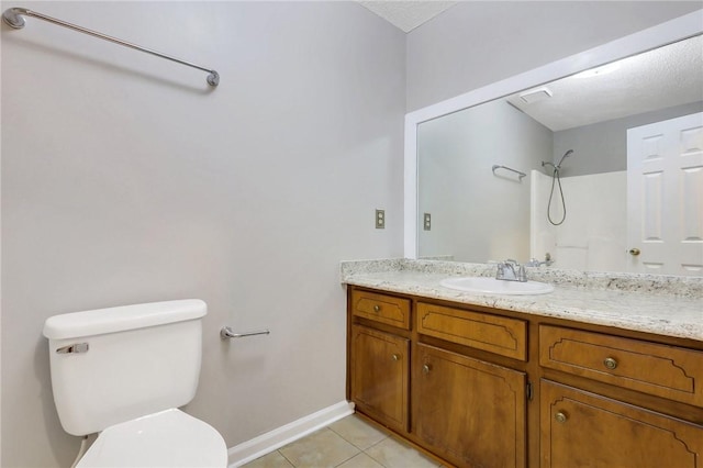 bathroom with vanity, toilet, tile patterned flooring, and a textured ceiling