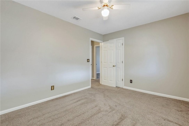 unfurnished room featuring ceiling fan and carpet flooring