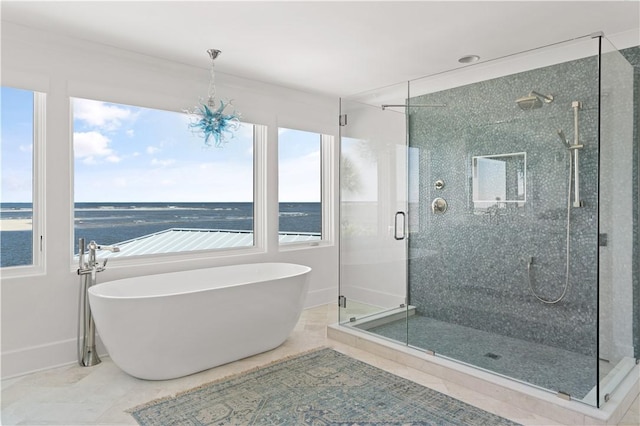 bathroom with a water view and shower with separate bathtub