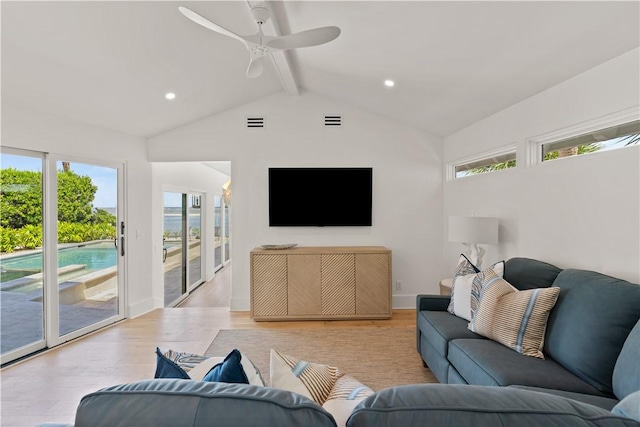 living room featuring a wealth of natural light, ceiling fan, lofted ceiling with beams, and light wood-type flooring