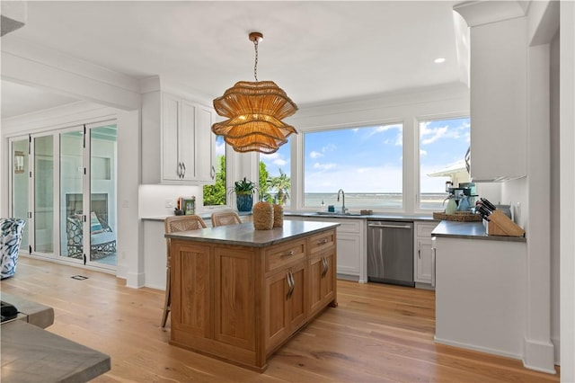 kitchen featuring a center island, dishwasher, white cabinets, and light hardwood / wood-style flooring