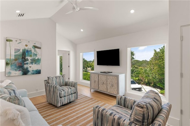 living room featuring light wood-type flooring, vaulted ceiling, plenty of natural light, and ceiling fan