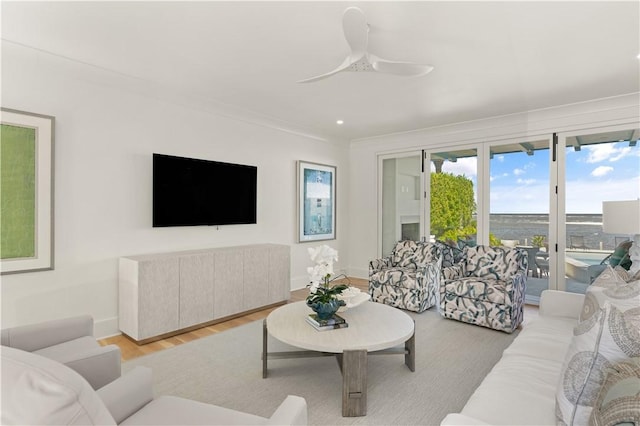 living room with light hardwood / wood-style flooring and ceiling fan