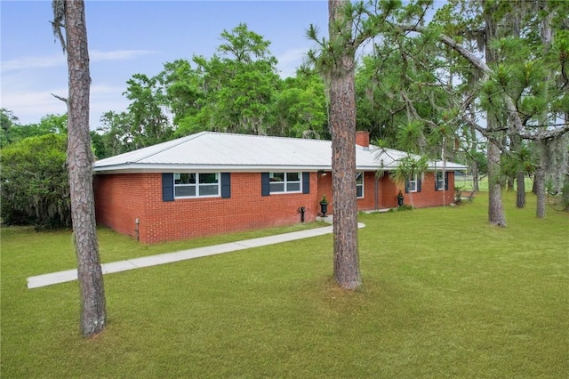 703 Wayne St, Darien, GA 31305 - ranch-style home featuring a front lawn, brick siding, and a chimney
