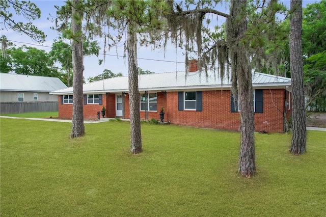 703 Wayne St, Darien, GA 31305 - ranch-style home with brick siding, a chimney, and metal roof