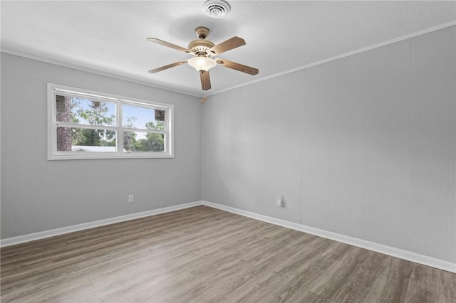 703 Wayne St, Darien, GA 31305 - empty room with wood finished floors, a ceiling fan, and baseboards