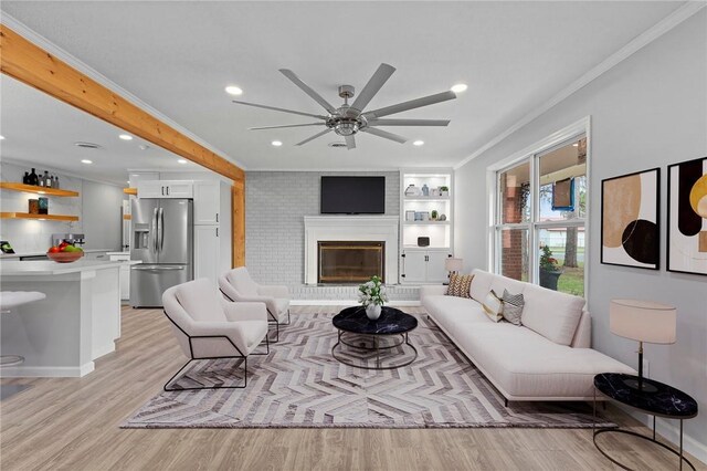 703 Wayne St, Darien, GA 31305 - living area with crown molding, light wood-style floors, a ceiling fan, recessed lighting, and a brick fireplace