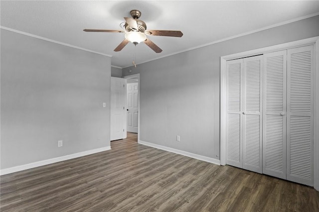 703 Wayne St, Darien, GA 31305 - unfurnished bedroom featuring dark wood-type flooring, baseboards, a closet, crown molding, and a ceiling fan
