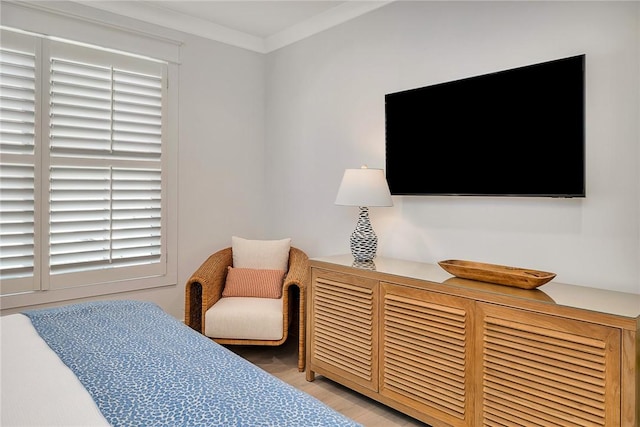 bedroom featuring wood-type flooring and ornamental molding