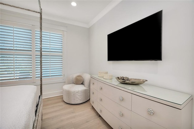 bedroom with multiple windows, crown molding, and light wood-type flooring