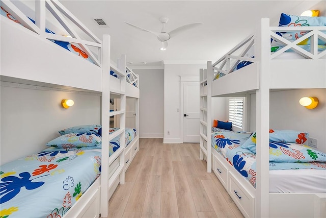 bedroom with ceiling fan, light wood-type flooring, and ornamental molding