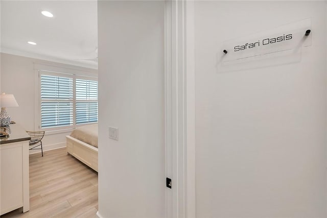 bedroom with crown molding and light wood-type flooring