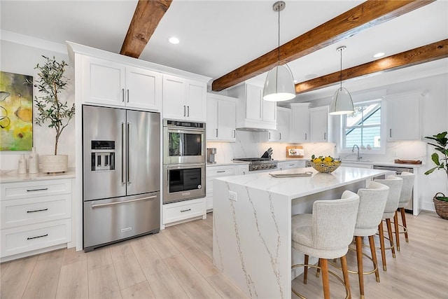 kitchen featuring beamed ceiling, a center island, white cabinetry, and stainless steel appliances