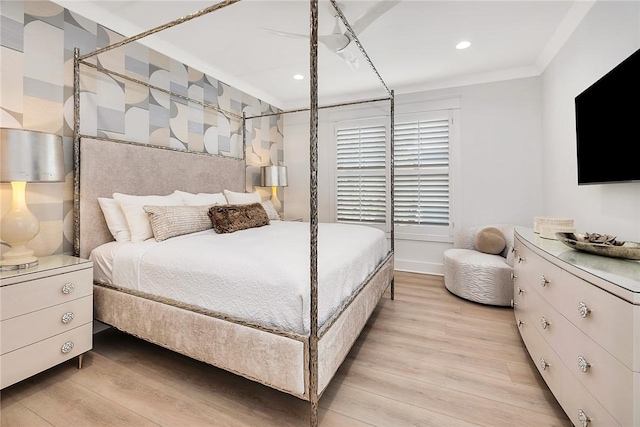 bedroom with crown molding and light wood-type flooring