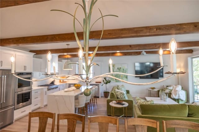 interior space featuring beamed ceiling and light wood-type flooring