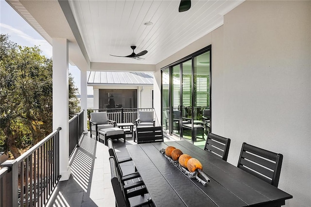 exterior space featuring ceiling fan, a balcony, and an outdoor living space