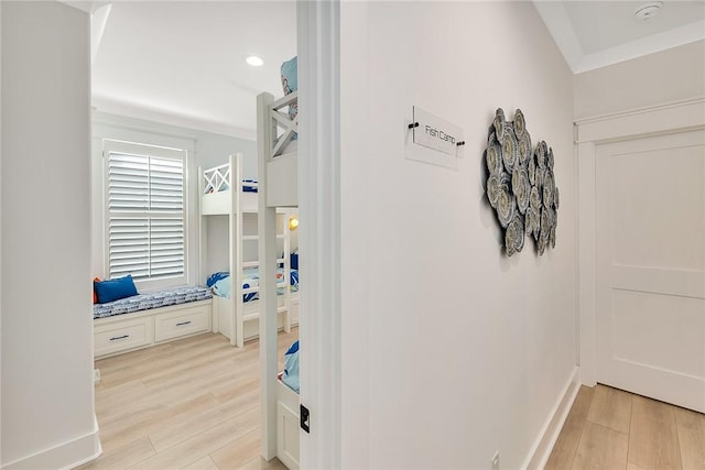 bathroom with crown molding and hardwood / wood-style flooring