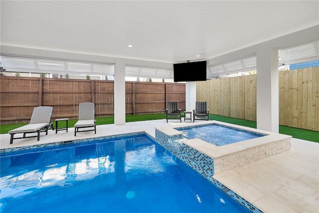 view of swimming pool featuring a patio area and an in ground hot tub