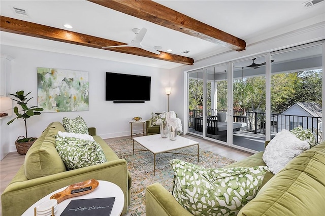 living room with beam ceiling, ceiling fan, and light wood-type flooring