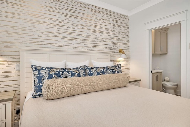 bedroom with ensuite bath and crown molding