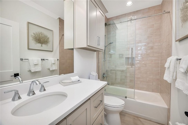 full bathroom with toilet, vanity, and combined bath / shower with glass door