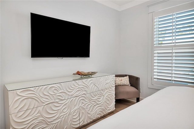 bedroom with hardwood / wood-style flooring and crown molding