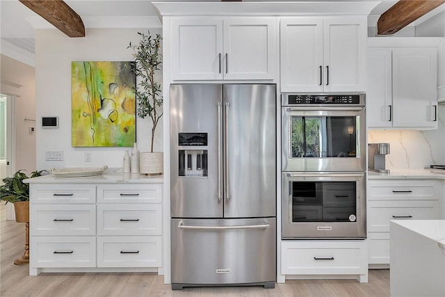 kitchen featuring white cabinets, stainless steel appliances, and light hardwood / wood-style floors