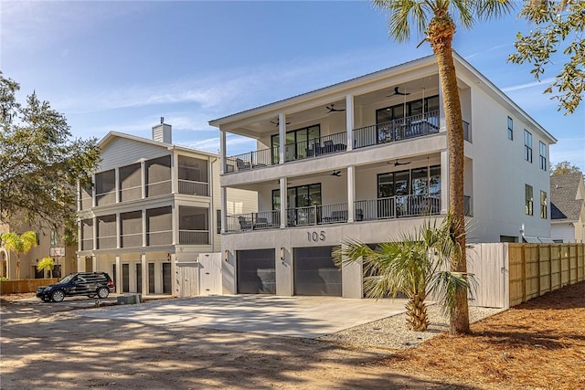 view of front facade featuring a sunroom, a garage, and a balcony