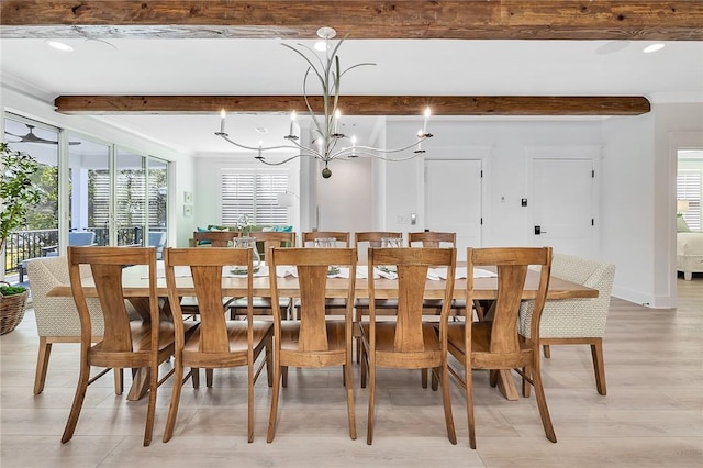 dining room featuring beam ceiling, plenty of natural light, a chandelier, and light hardwood / wood-style flooring